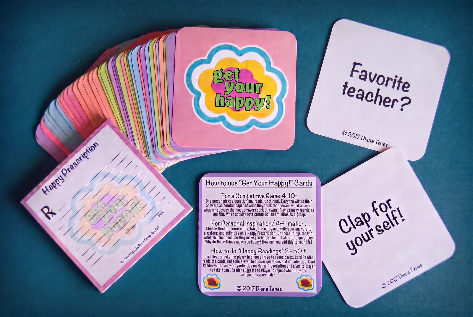 The colorful Get Your Happy! card box with the full deck, instructions and Happy Prescription pad